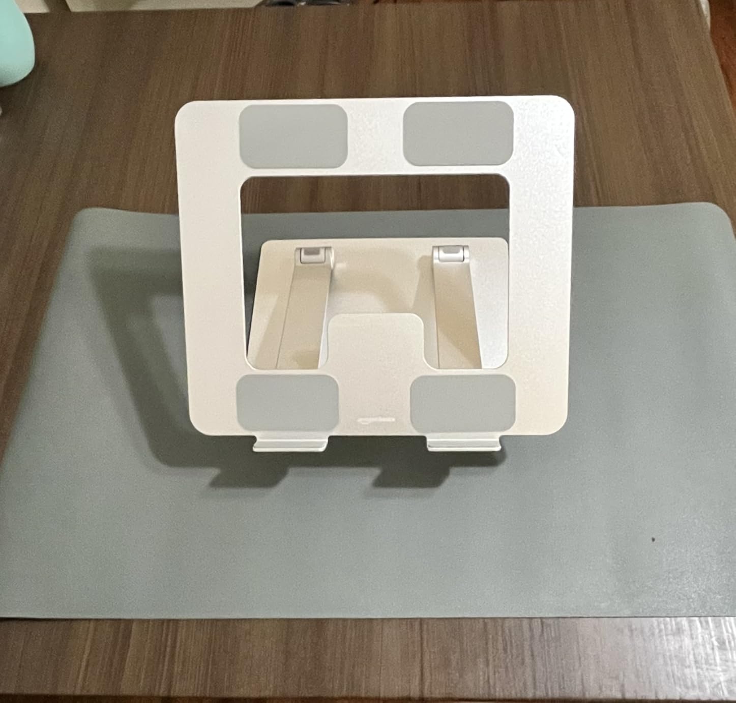 Amazon Basics Sturdy and Portable Ergonomic Laptop Stand for Desk, Height Adjustable Riser with Ventilated Cooling, Foldable, Fits all Laptops up to 17.3 Inch, Silver, 10 x 8.7 x 6 in customer photo 1