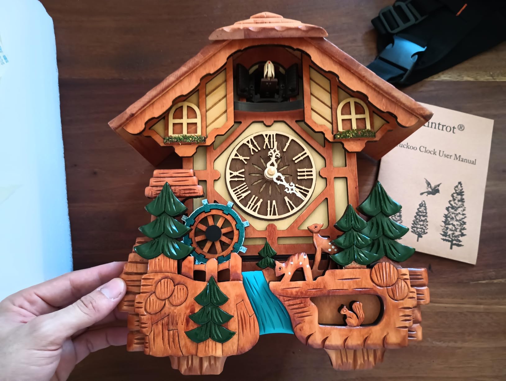 Kintrot Cuckoo Clock Black Forest Chalet Clock 11x22.5 Inches | Handcrafted Wooden Wall Clock with Singing Bird, Rotating Waterwheel, Night Mode and 12 Melodies customer photo 2