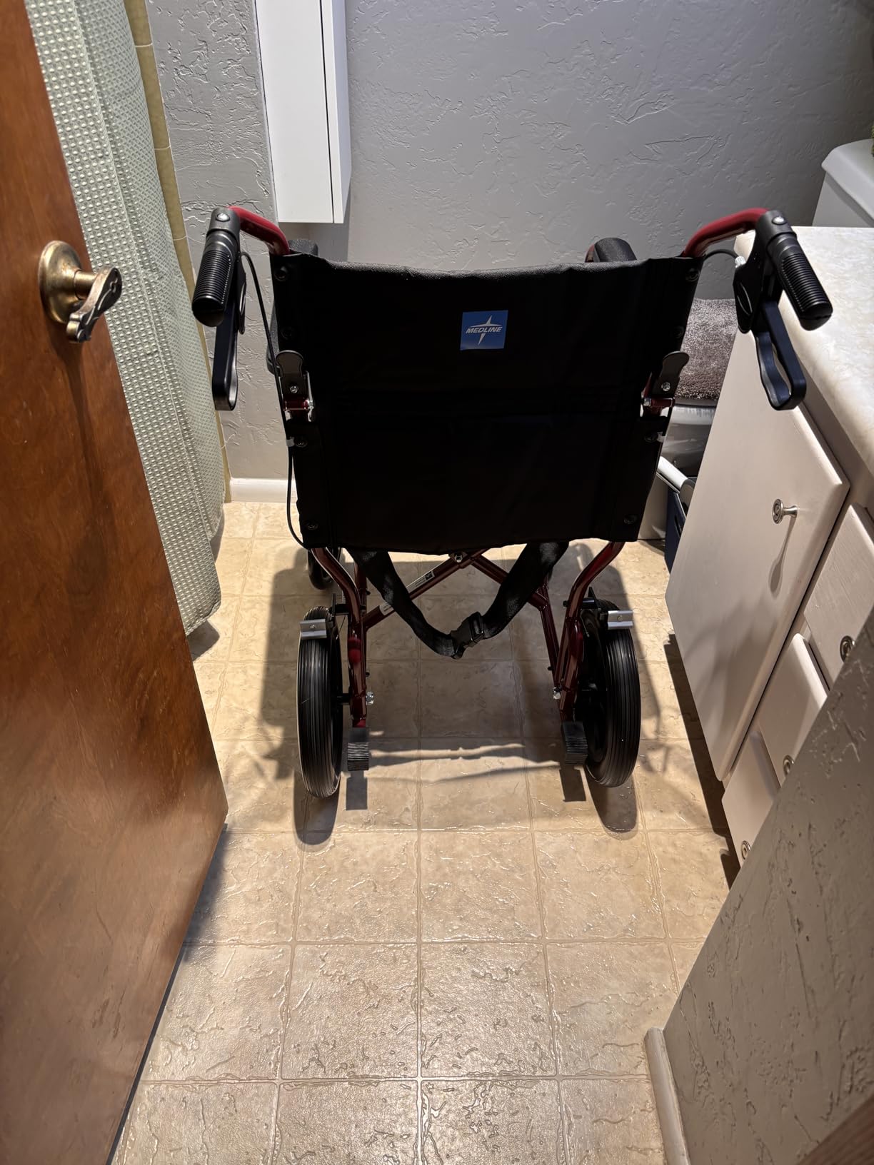 Medline Lightweight Foldable Transport Wheelchair with Handbrakes and 12-Inch Wheels, Blue Frame, Black Upholstery customer photo 1