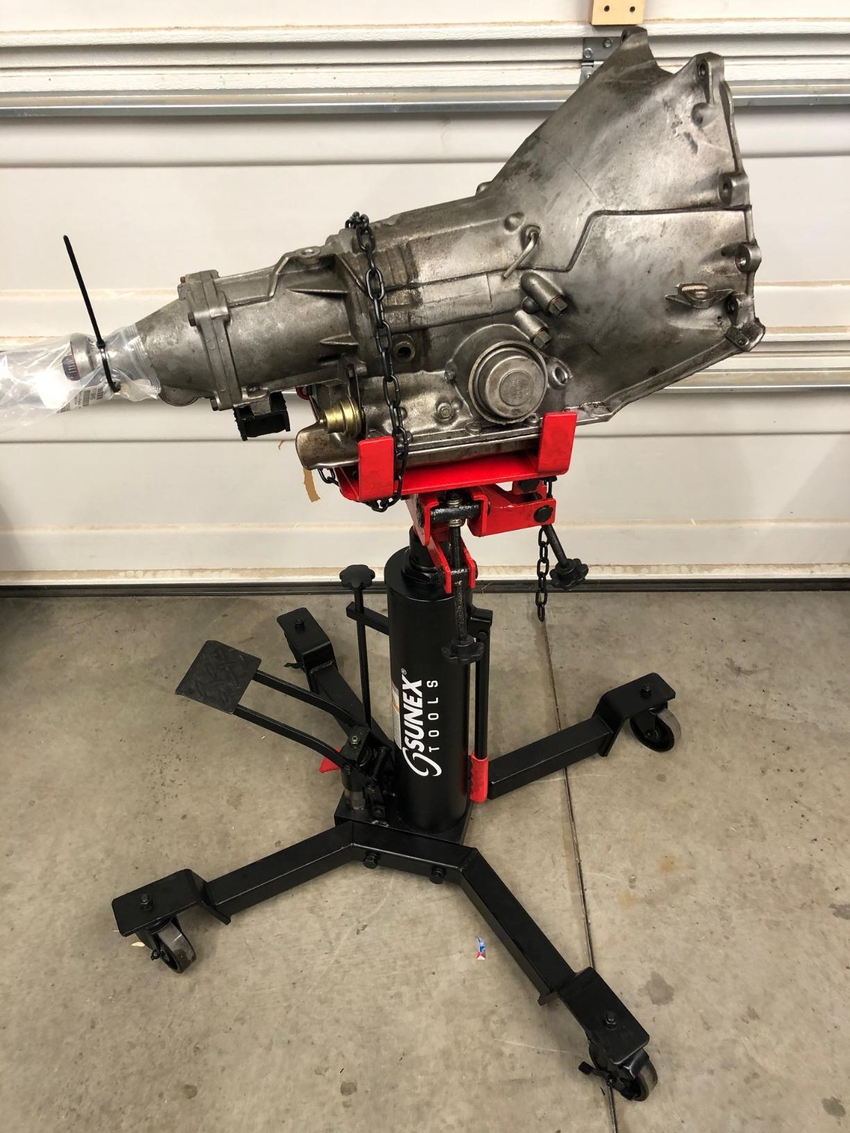 Sunex Tools 7793B 1,000 lb Telescopic Transmission Jack, Hydraulic, Foot Pump Operated, Tilt Saddle with Chain Tie-Down, 74.2 in Max Height customer photo 2